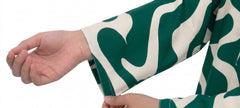 Plum Lilen (imported Fabric) printed Green & White Patterns with Green buttons on 2pc stitched suit for Girls.